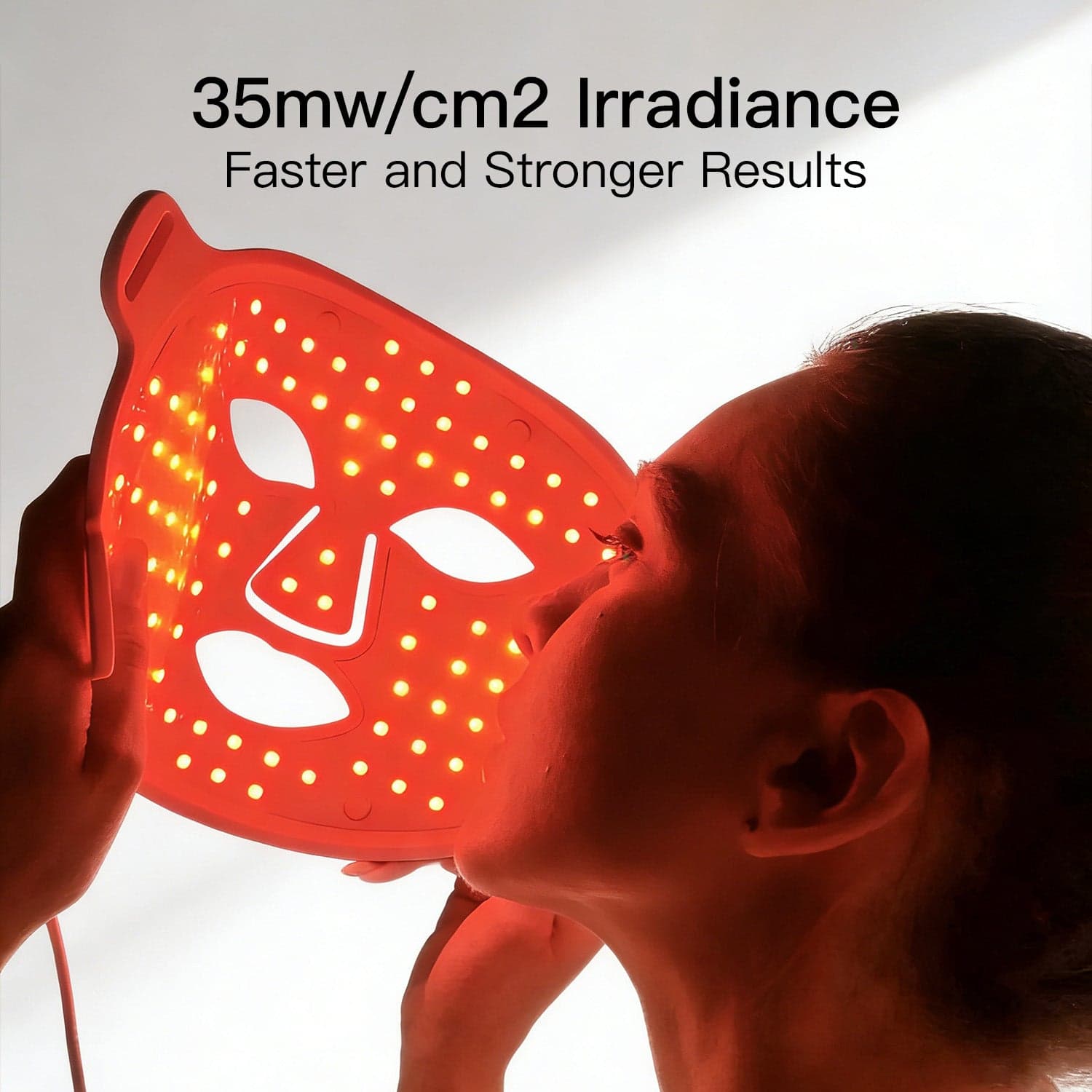 Side view of a person holding the illuminated MEGELIN JML1 face mask.