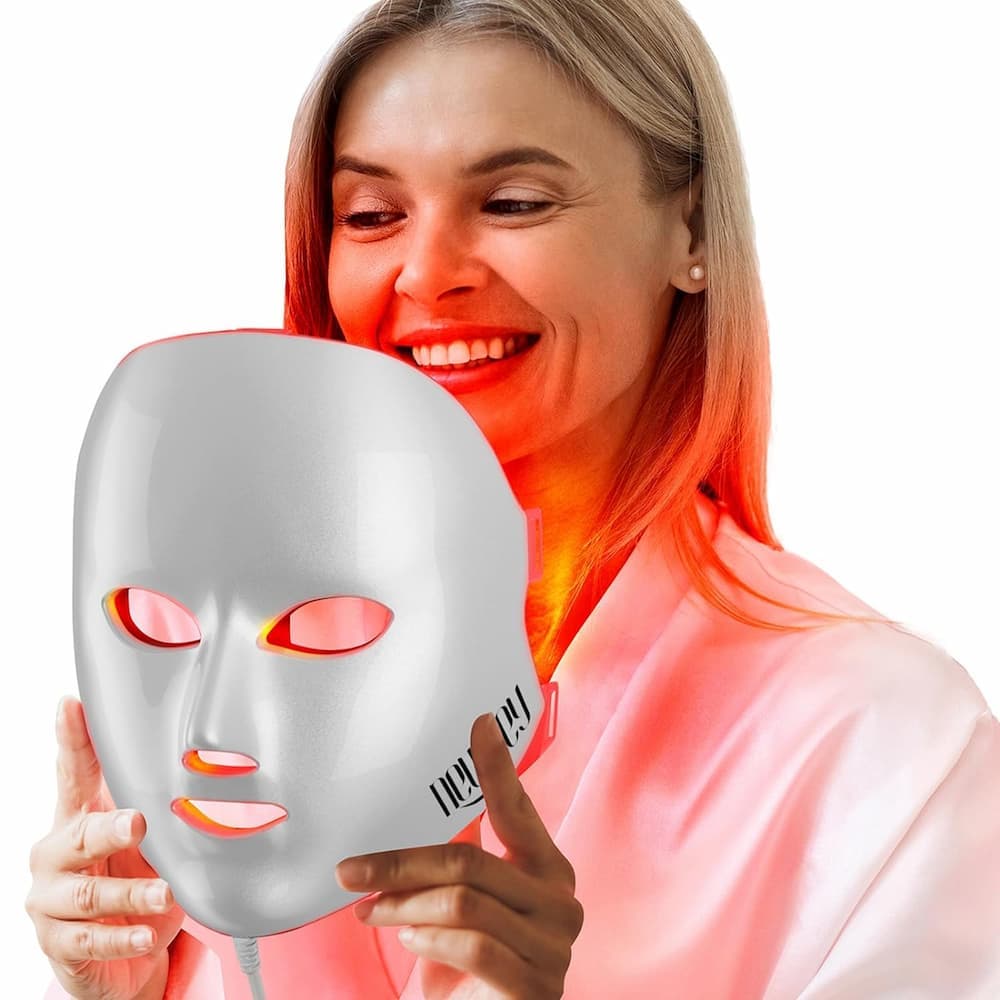 Three-quarter view of the NEWKEY 4D LED mask lit in red mode, held at the chin with the power cord visible